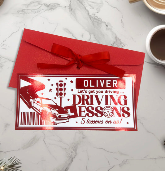 Driving lessons gift card with red envelope on a marble surface