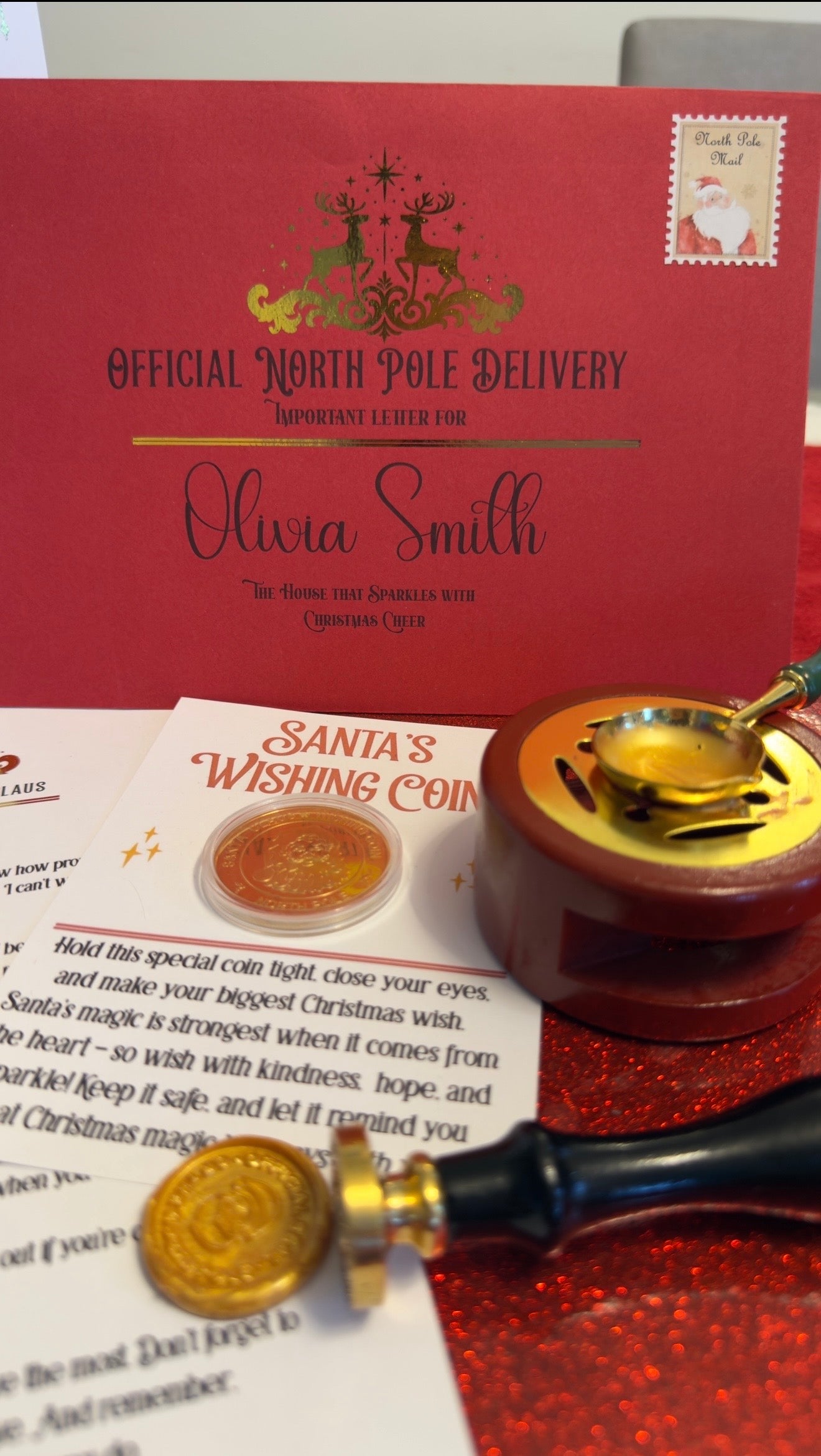 Santa's Wishing Coin with red box and letter on a red glittery background