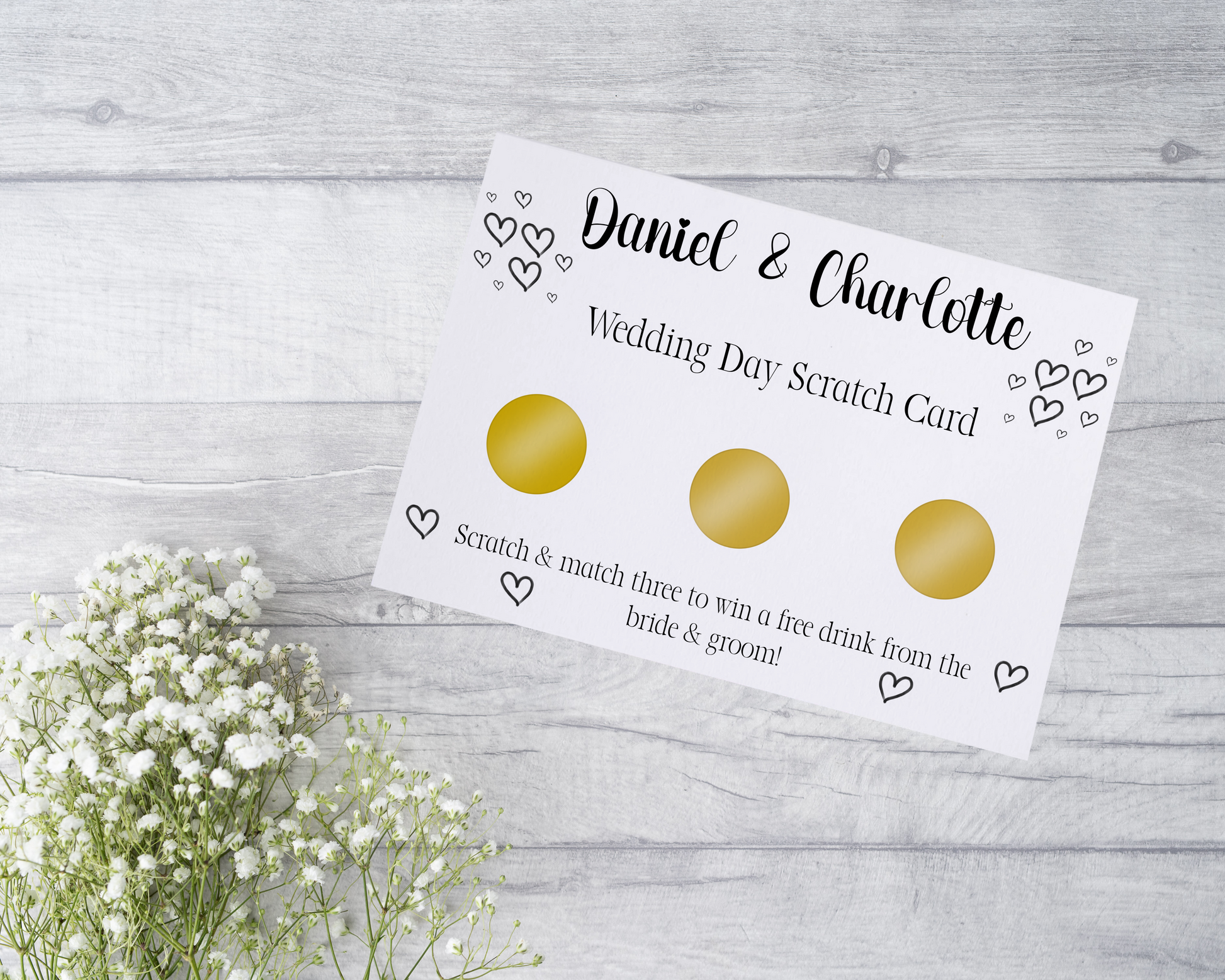  A close-up view of a beautifully designed scratch card with elegant typography and decorative elements. The scratch card features customised names and a wedding date, surrounded by symbols representing hidden prizes. The card is held by a hand, ready to be scratched off, adding an element of anticipation and excitement.
