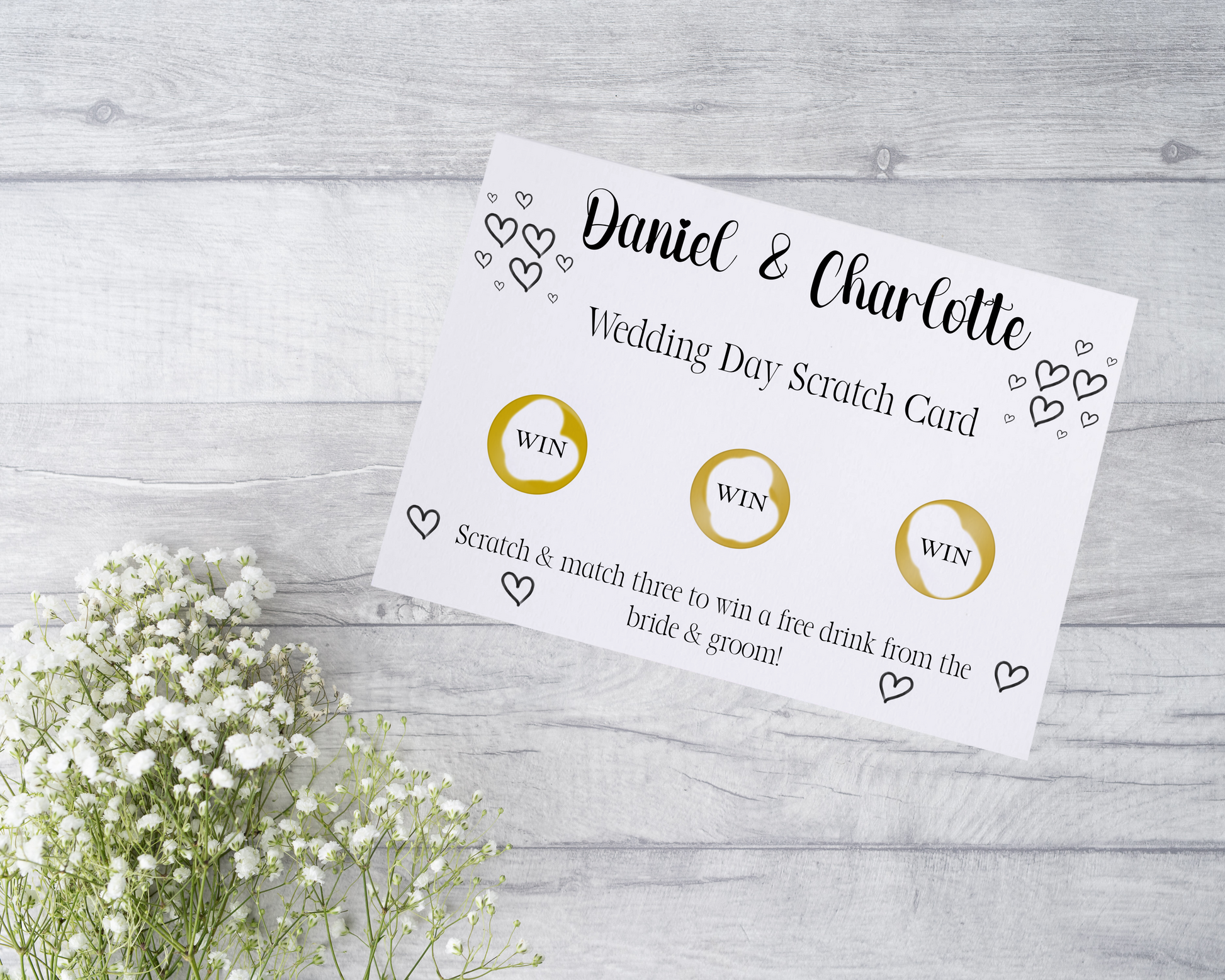  A close-up view of a beautifully designed scratch card with elegant typography and decorative elements. The scratch card features customised names and a wedding date, surrounded by symbols representing hidden prizes. The card is held by a hand, ready to be scratched off, adding an element of anticipation and excitement.