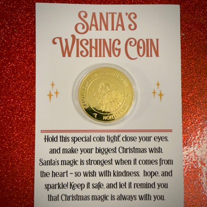 Gold Wishing coin in a clear plastic sleeve on a card with text about Santa's Wishing Coin, against a red glittery background.