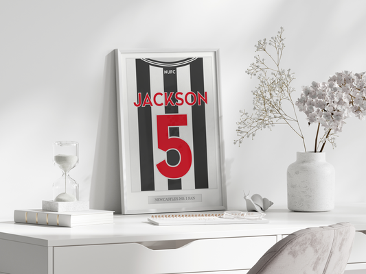 A personalised sports jersey back print hung on a wall in a tastefully decorated room, proudly featuring the team colours and custom name and number. Ideal for enhancing the ambiance in a child's bedroom, man cave, or sports bar